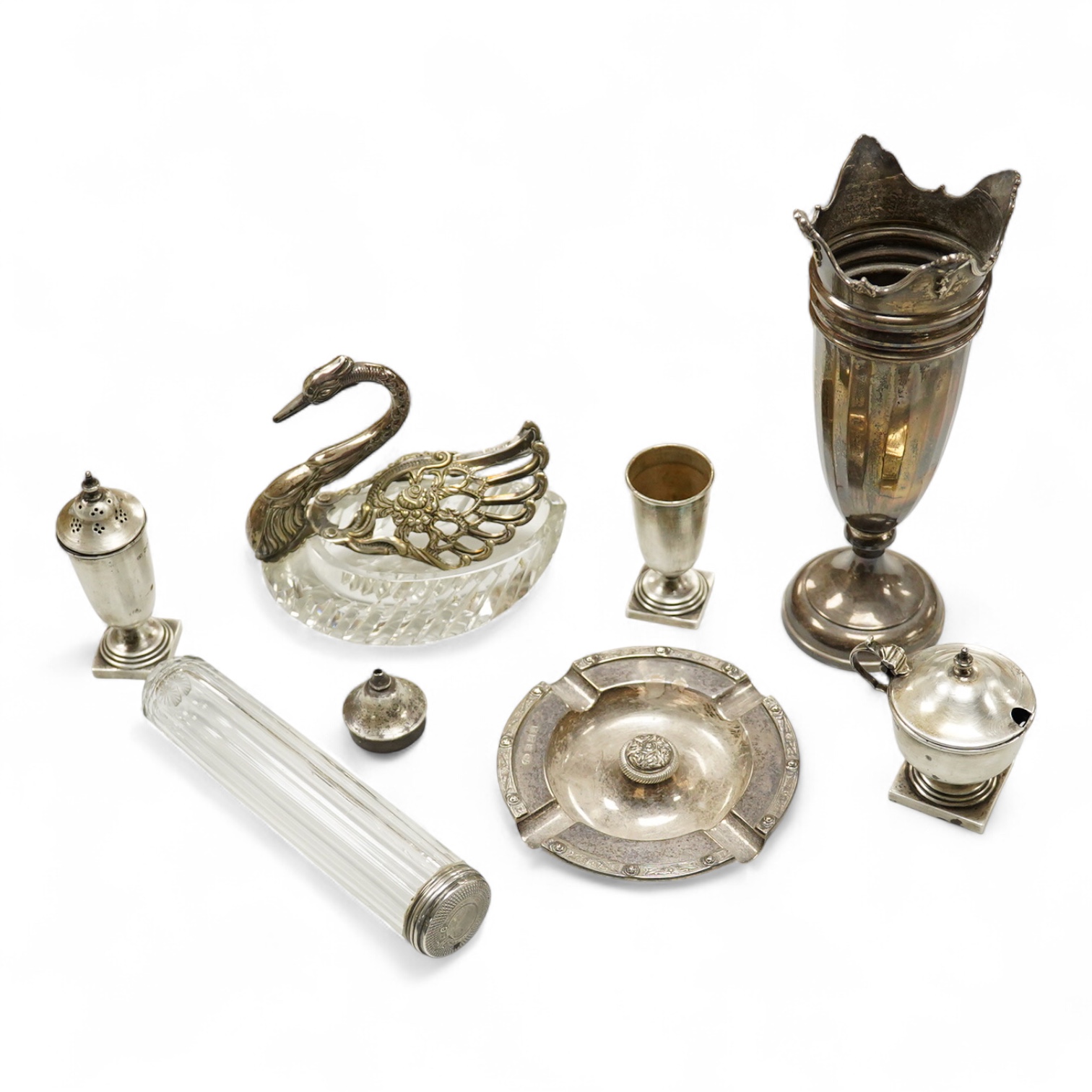 An Elizabeth II silver mounted vase with wavy border, Adie Brothers, Birmingham, 1955, weighted, 20.4cm, a silver mounted glass swan bonbon dish, a George V silver three piece condiment set, a silver mounted glass toilet